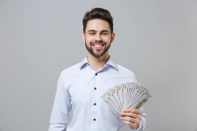 small business owner flashing cash